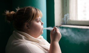 A young woman smokes in Russia. WHO/Sergey Volkov