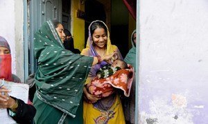 In Bhujpura, India, a team of vaccinators knock on doors and check if any child did not receive the polio vaccine. Each house is marked accordingly so that they have a record of the work completed. © UNICEF/INDA2015-00025/Biswas