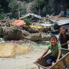 Three children play with a rusted wheelbarrow in the town of Singati, near the town of Charikot in Dolakha District, Nepal, epicentre of the 12 May earthquake.