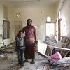 Abdallah and his six-year-old son stand in what used to be the entrance of their home, in Sana’a’s Bayt Mayad neighbourhood.