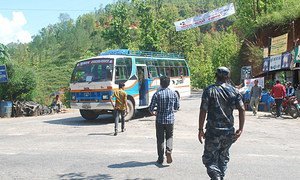 At the Bandeu checkpoint in Nepal, inspectors and a police constable approach a bus to look for potential victims of child trafficking onboard.