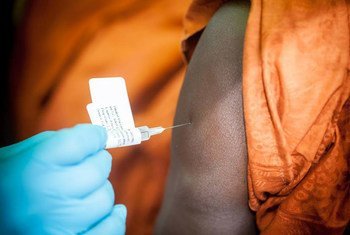 The Ebola vaccine is administered to a participant in the trial in Guinea.