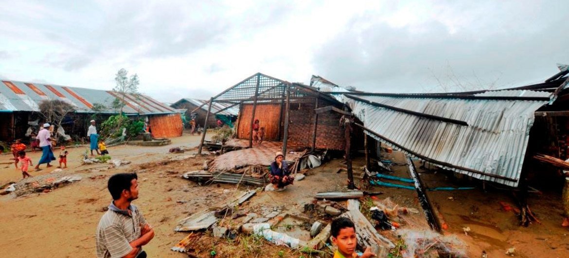 Residents survey the damage caused by cyclone Komen that swept across western Myanmar.