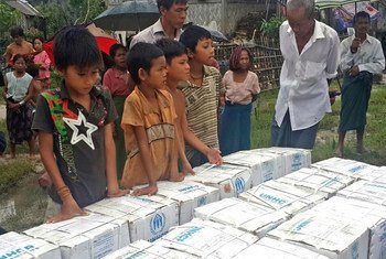 Children in Myanmar wait during distribution of household items for people affected by Cyclone Komen, in Ka Ye Nyaing, Maungdaw township, Rakhine State.