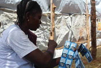 A health worker in South Sudan counts water purification sachets for distribution to patients upon being discharged from the cholera treatment unit, as part of concerted efforts to contain the outbreak.