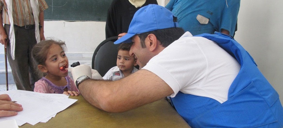 UNRWA doctor examines a child in Yalda, Damascus, Syria, on 19 August 2015.