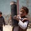 صبي يحمل قطعة كبيرة من قذيفة مدفعية سقطت في المحجر في ضواحي صنعاء، عاصمة اليمن. المصدر: / محمد حمود