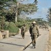 Ugandan soldiers serving with the African Union Mission in Somalia (AMISOM), walk across a bridge near the town of Janaale, Somalia.