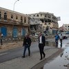 Humanitarian Coordinator for Yemen, Johannes Van Der Klaauw (foreground, right) and members of the inter-agency mission in a street of Sa’ada where shops were destroyed by airstrikes in August 2015.
