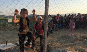 Children stand near the reception centre close to the town of Gevgelija, in the former Yugoslav Republic of Macedonia on 4 September 2015, after crossing the border from Greece together with their families.