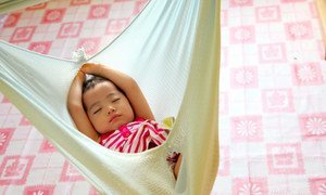 A baby from the indigenous Kadazandusun ethnic group sleeps in a traditional cloth cradle in a learning and child-care centre in the district of Penampang, Malaysia. UNICEF supports education and other programmes for indigenous and other marginalized, vulnerable children in the country.