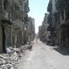 A street lined with rubble and destroyed buildings in the Old City area of Homs, Syria.