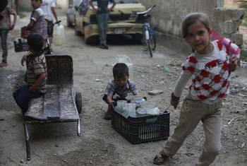 Children fetch water in the town of Douma in the East Ghouta area of Rural Damascus, Syria.