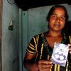 Vijitha Pavanendran holds a photo of her husband who was killed by unknown attackers during Sri Lanka's civil war.