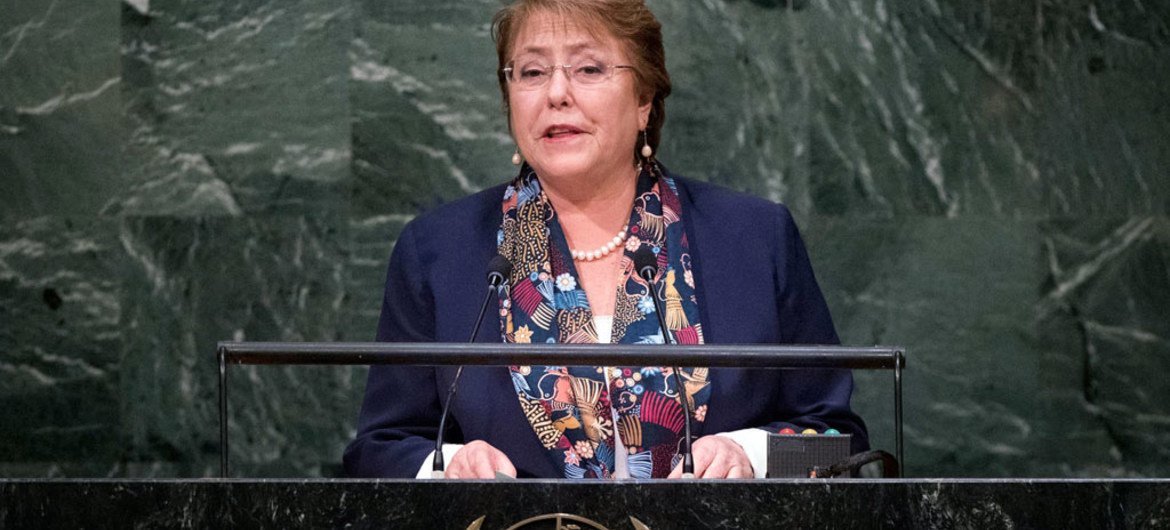 Michelle Bachelet speaks at a podium bearing the United Nations emblem.