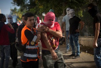 A Palestine Red Crescent Society responder tends to the wounded during a Bethlehem skirmish. Clashes with the Israeli army in the West Bank have left many injured by rubber bullets and tear gas.