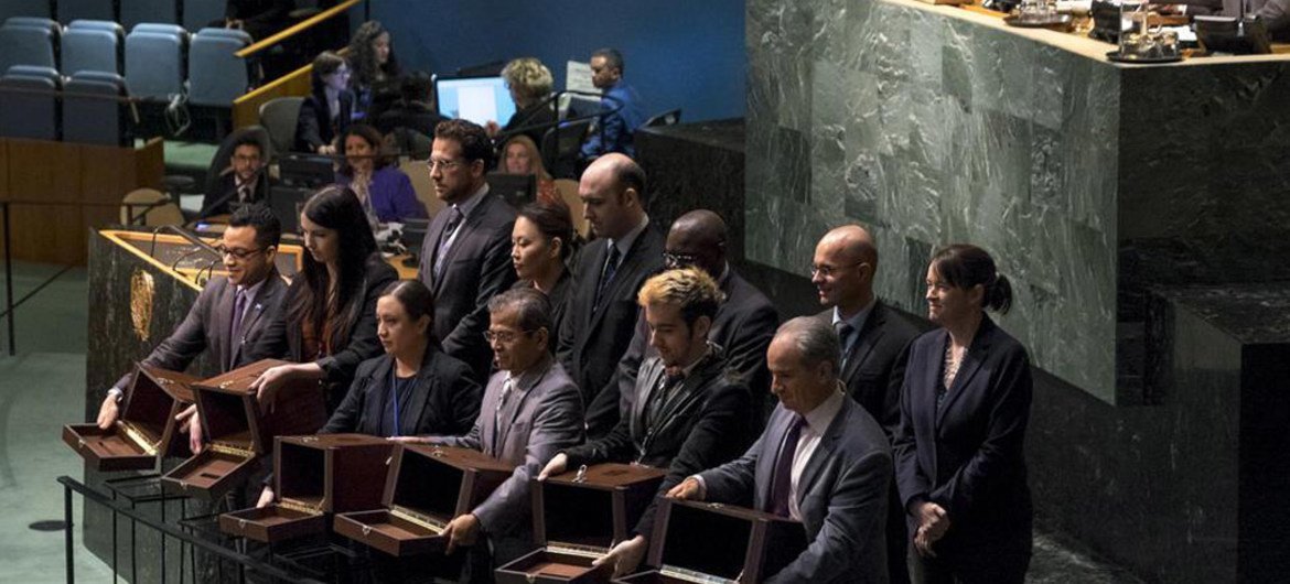 Conference officers hold up empty ballot boxes for inspection prior to the vote to elect five non-permanent members of the Security Council.