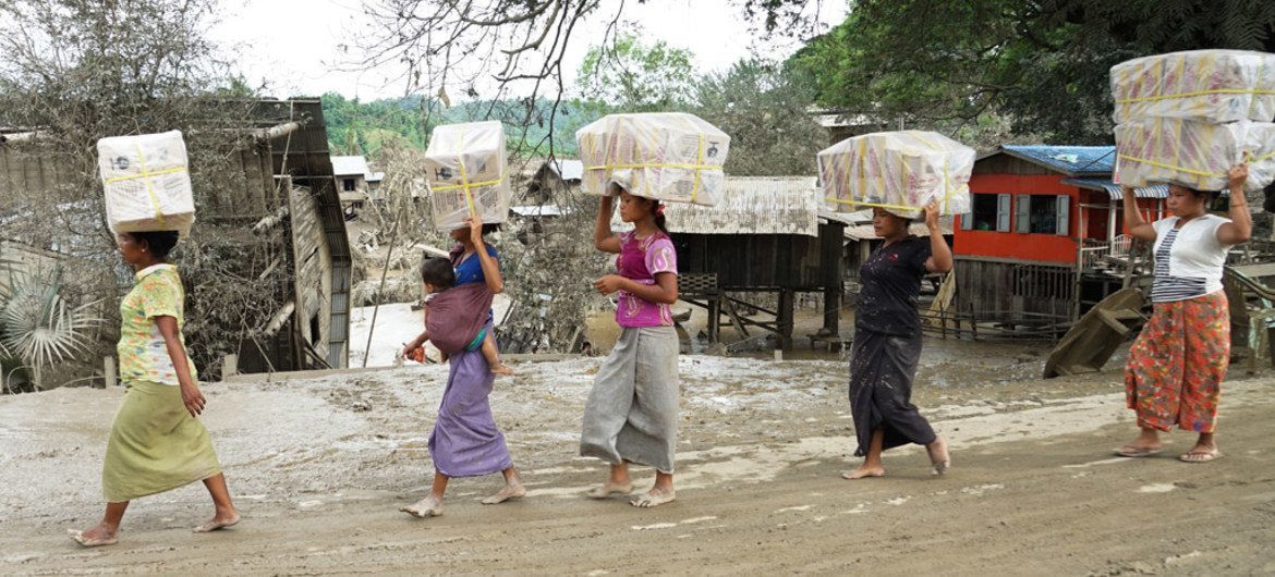 Women carry food to their camp at Kalay township in Sagaing State, northwest Myanmar, which suffered some of the worst devastation from floods in the area.