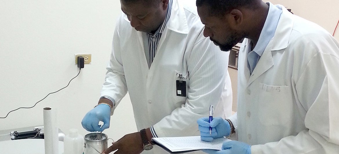 International Centre for Environmental and Nuclear Sciences (ICENS) Director General Charles Grant (left) and Johann Antoine, Head of the Nuclear Analytical Lab, are shown assembling a low enriched uranium (LEU) core for use in Jamaica’s Slowpoke research reactor.