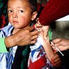 A young boy is administered measles and rubella vaccine at a health post in Gorkha District, Nepal.
