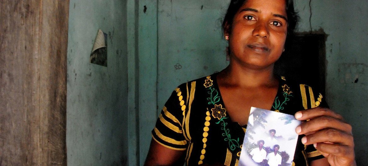 Vijitha Pavanendran holds a photo of her husband who was killed by unknown attackers during Sri Lanka’s civil war.