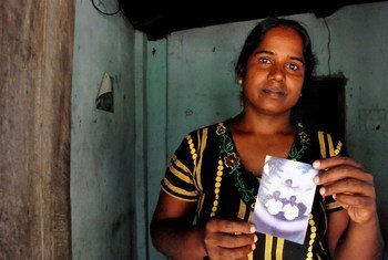 Vijitha Pavanendran holds a photo of her husband who was killed by unknown attackers during Sri Lanka’s civil war.