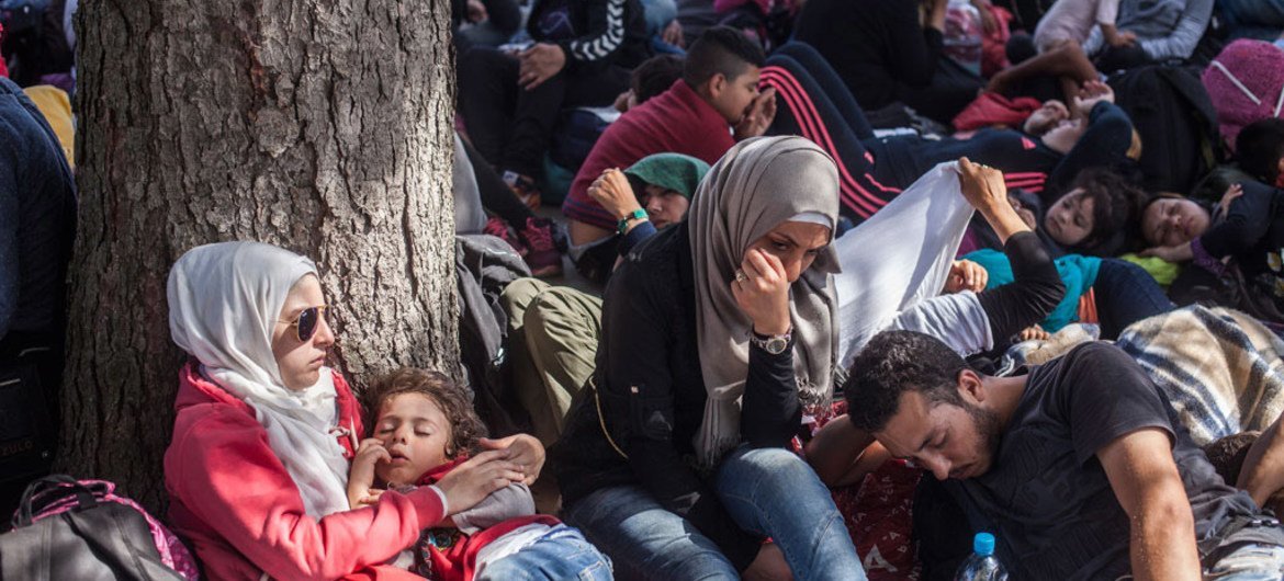 A group of asylum-seekers break the trek to rest at Tovarnik train station in Croatia.