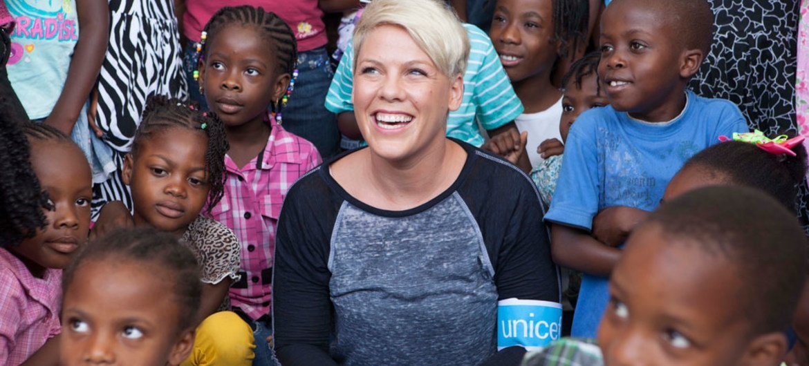 P!nk visits with children during a trip to Haiti with UNICEF.