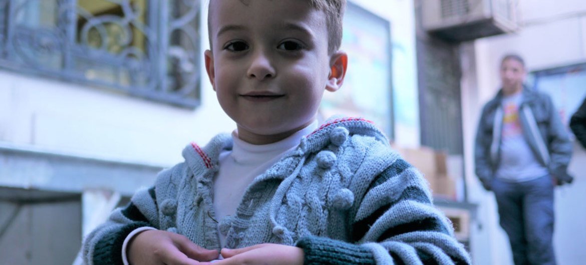 A young boy at a UNICEF winter supplies distribution centre in Damascus, Syria.