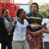 Titi Akosa leads singing and dancing on Gender Day at COP21, highlighting the need for more women to be involved in negotiating the new climate change agreement.