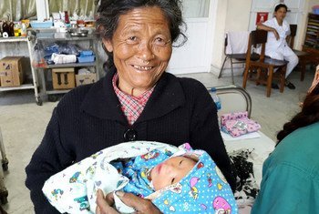 A Nepali grandmother holds her daughter’s newborn baby at the UNICEF-supported Patan Hospital in Kathmandu.