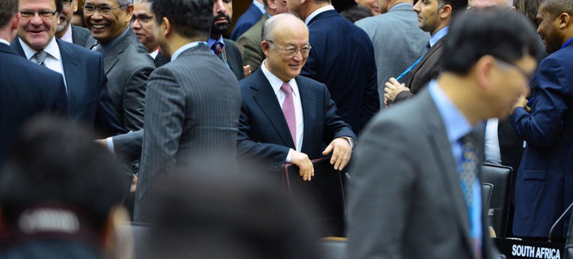 IAEA Director General Yukiya (centre) makes his way to the boardroom just before the start of the 1425th Board of Governors meeting in Vienna, Austria.