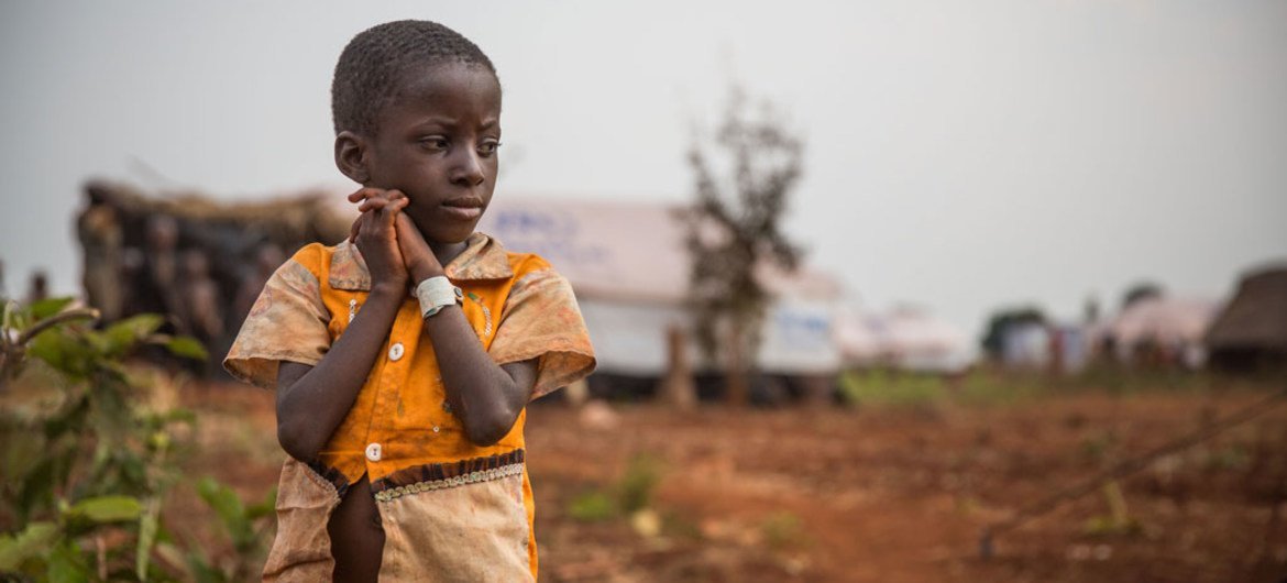 A young boy from Burundi, forced to flee his home due to violence, looks at his new surroundings in the Nyarugusu refugee camp in Tanzania.