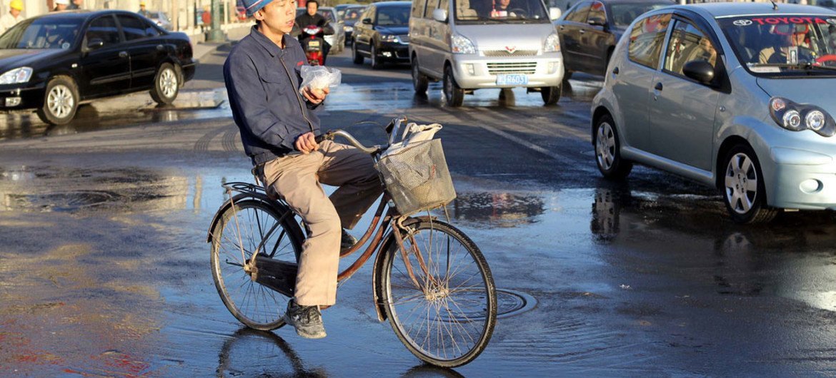 A migrant worker on his bicycle in Tianjin, China.