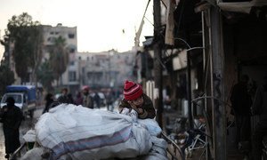 A family flees an active conflict neighbourhood in eastern Ghouta, Syria, using a cart to carry their belongings.