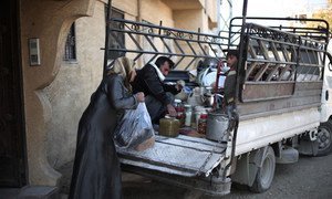 In December 2015, a mother loads preserved food supplies in a truck as the family prepares to move out of Nashabieh village to a neighbouring safer town within besieged East Ghouta, Syria.  Almost 400,000 people are trapped in besieged locations.