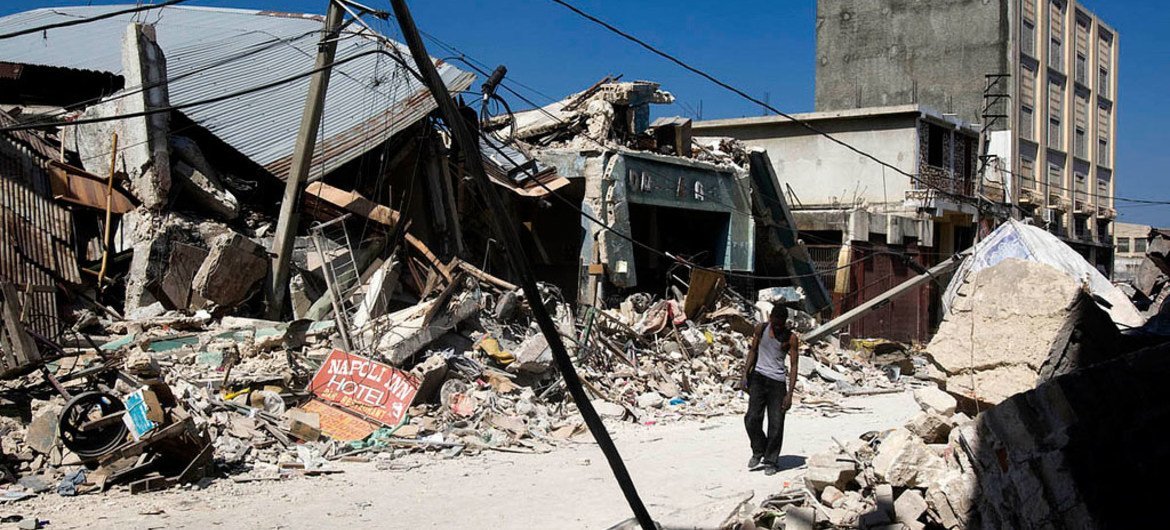 A man walks through rubble of collapsed buildings in downtown Port au Prince, Haiti, which was rocked by a massive earthquake, on Tuesday 12 January 2010, devastating the city and leaving thousands dead.