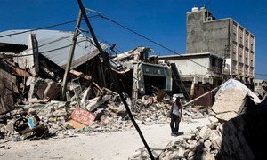 A man walks through rubble of collapsed buildings in downtown Port au Prince, Haiti, which was rocked by a massive earthquake, on Tuesday 12 January 2010, devastating the city and leaving thousands dead.