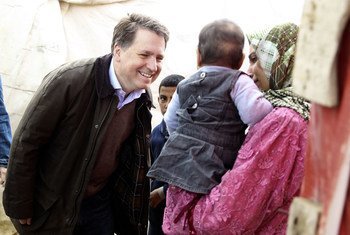Chief Executive of Save the Children UK Justin Forsyth speaks with a Syrian refugee woman and her child, in the Faida informal tented settlement, Bekaa Valley, Lebanon.
