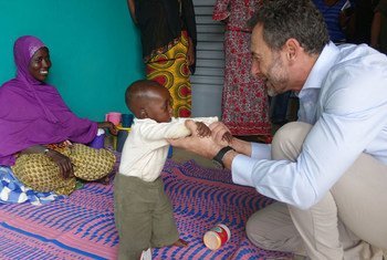 Regional Humanitarian Coordinator for the Sahel, Toby Lanzer, plays with a child at a Gao malnutrition treatment center in Mali.