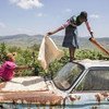 Drying corn on the hood of the family truck in Manyandzeni Village, Swaziland.