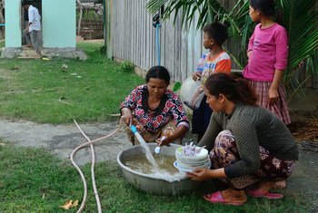 Women wash dishes in Kraing Serey village, Kampong Speu province, Cambodia.