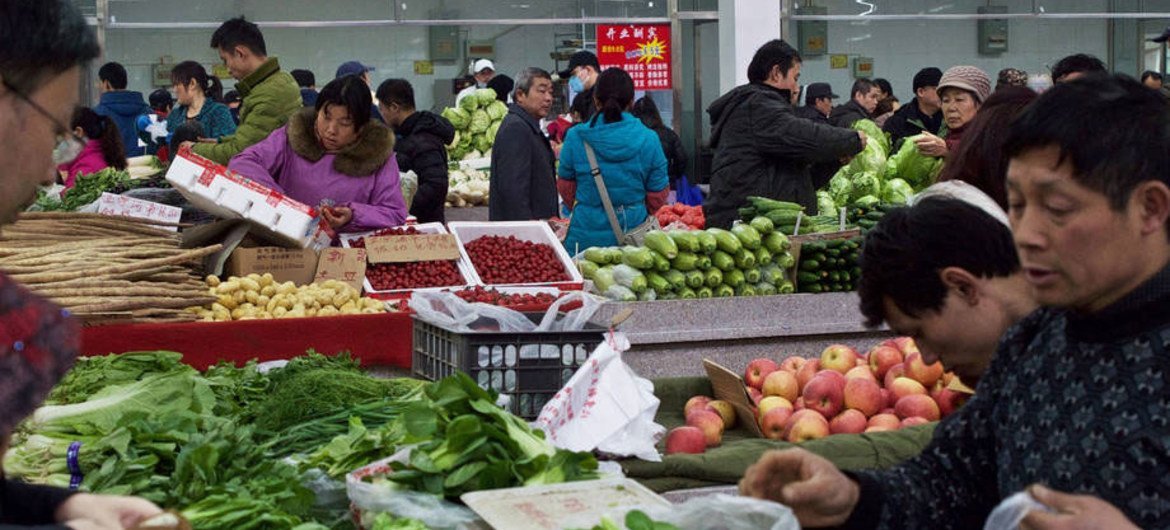 Shoppers in Beijing, China, buying fresh produce.