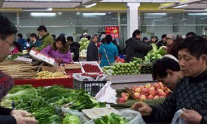 Shoppers in Beijing, China, buying fresh produce.