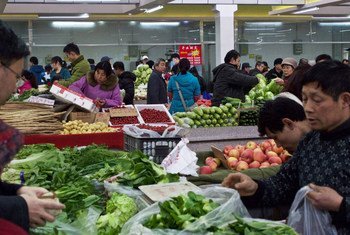 Shoppers in Beijing, China, buying fresh produce.