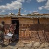Drought-affected people in the Afar Region of Ethiopia – one of the hardest hit with all 32 of its woredas (districts) classified as a nutrition ‘priority 1’ – carry wheat donations to a rented corrugated iron store.