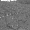 In 1996 in Rwanda, wooden crosses mark the graves in a cemetery in the village of Nyanza in a rural area of Kigali, the capital. During the 1994 genocide, over 10,000 people were burned to death in Nyanza as they tried to escape towards Burundi.