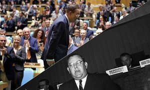 Secretary-General Ban Ki-moon bows to the General Assembly after his re-appointment in 2011 as the eighth Secretary-General (top). The first Secretary-General Trygve Lie speaks at the Palais des Nations in Geneva, 1950.