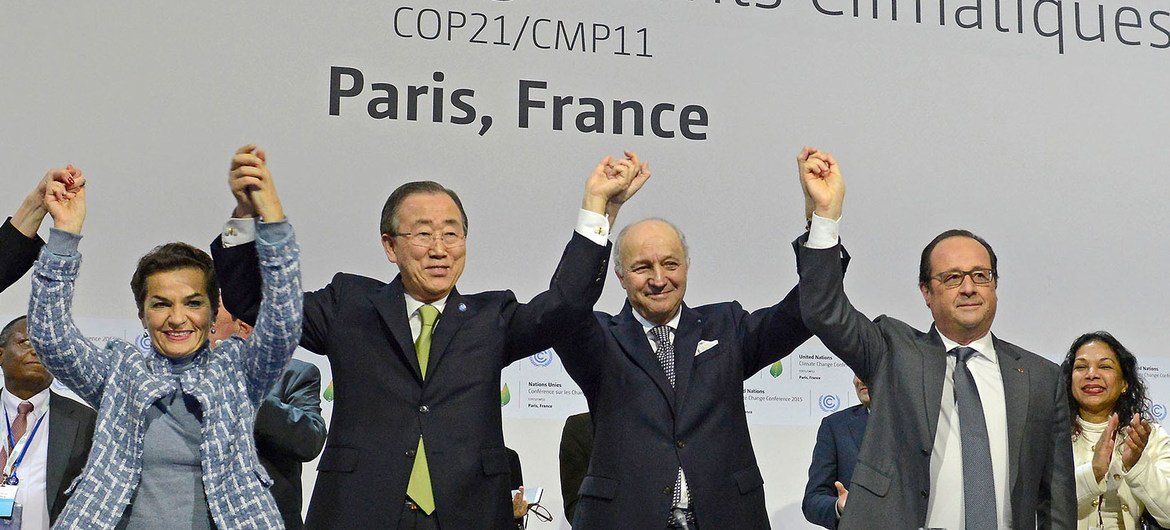 Secretary-General Ban Ki-moon (second left), UNFCCC's Christiana Figueres (left), French Foreign Minister Laurent Fabius and President of the UN Climate Change Conference in Paris (COP21), and President François Hollande of France (right), celebrate histo