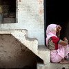 A woman outside her small home in Kanpur, Uttar Pradesh,